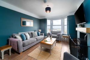 a living room with a couch and a table at Porthmeor View in St Ives