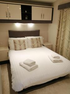 A bed or beds in a room at No1 Borwick Lakes
