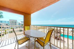 a balcony with a table and chairs and the ocean at Holiday Villas III 201 in Clearwater Beach