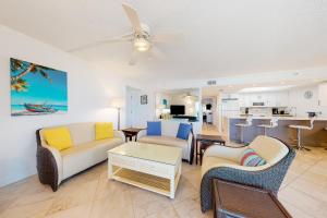 a living room with a couch and chairs and a table at Holiday Villas III 201 in Clearwater Beach