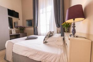 Postel nebo postele na pokoji v ubytování Hotel Viscardo