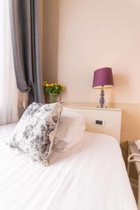 Postel nebo postele na pokoji v ubytování Hotel Viscardo