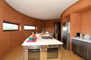 a kitchen with wooden walls and stainless steel appliances at Loop - An hedonist house in Tameslouht