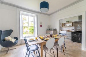 a kitchen and dining room with a table and chairs at Primrose Cottage in St Ives