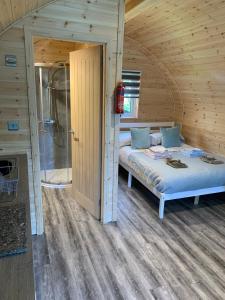 A bed or beds in a room at The Highland Hideaway Pod