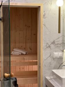 a bathroom with a sauna with a sink at Family & Business Sauna Tężnia Apartments No 20 Leśny nad Zalewem Cedzyna - 1 Bedroom with Private Sauna, Bath with Hydromassage , Terrace, Parking, Catering Options in Kielce +77 photos
