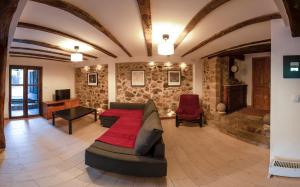 a living room with a couch and a table and chairs at Vivienda turística La Magdalena in Vallejuelo