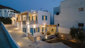 a large white building with lights on it at night at MNP Apartments in Engares