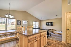 a kitchen with a large island in a room at Breezy Point Cabin with Fire Pit - Walk to Lake in Breezy Point