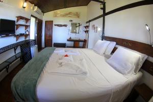 Ein Bett oder Betten in einem Zimmer der Unterkunft Pousada Santú