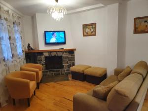a living room with a couch and a fireplace at Apartamento Marboré in Torla-Ordesa