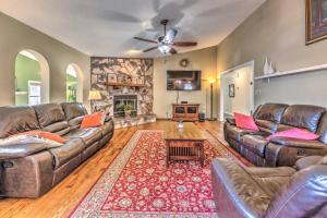 a living room with leather couches and a fireplace at Cloudcroft Escape with Forest Views! in Cloudcroft