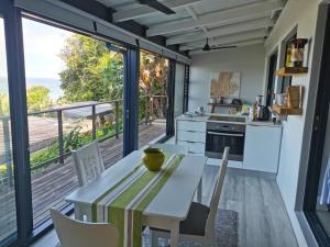 a kitchen with a table and chairs and a balcony at The Beach Bungalow in Durban
