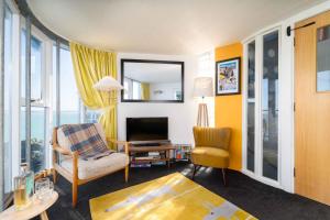 a living room with a chair and a television at The Lighthouse in St Ives