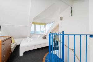 a small room with a bed and a staircase at The Lighthouse in St Ives