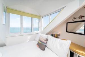 a room with a white couch and a window at The Lighthouse in St Ives +8 photos