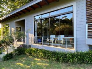 a home with large windows and a patio at YerbaBuena Lodge in Monteverde Costa Rica