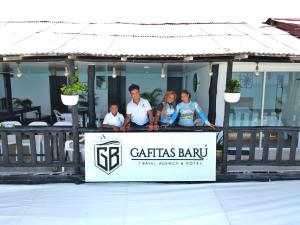 a group of people standing behind a sign at a restaurant at Gafitas in Playa Blanca