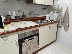 a kitchen with a sink and a stove top oven at Casa di nonno Memé CITRA 008035-LT-0018 in Andagna