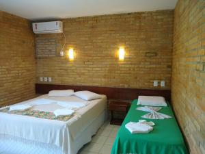 Postelja oz. postelje v sobi nastanitve Hotel Pousada Porto do Colibri