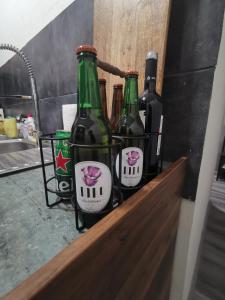 two bottles of beer in a basket on a shelf at Homey art apartment next to Drujba lake Metro stations and bul.Tsarigradsko Shose in Sofia