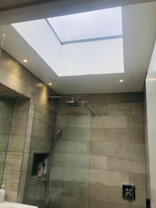 a skylight in a bathroom with a shower at The garden studio 85 in Chesterton