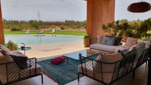 a living room with a couch and a pool at Loop - An hedonist house in Tameslouht