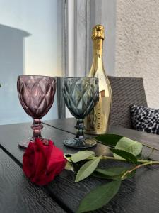 a table with two glasses and a bottle of wine at Romantic room for two persons in Poreč