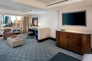 a hotel room with a flat screen tv and a desk at InterContinental Boston, an IHG Hotel in Boston