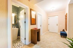 a hallway with a bathroom with a sink and a toilet at Pool House Mamaia in Mamaia Nord +51 photos