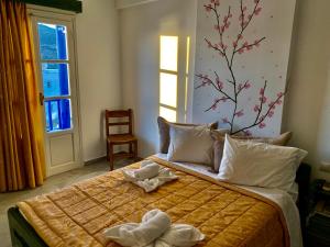 a bedroom with a bed with towels on it at Pelagos in Aegiali