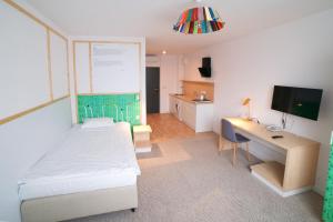 Telewizja i/lub zestaw kina domowego w obiekcie Arche Hotel Poloneza