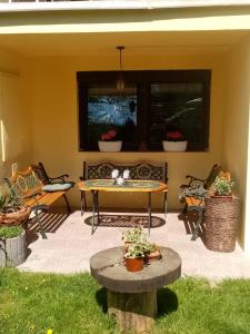a patio with a table and chairs in a yard at Apartman Ivana in Rumburk