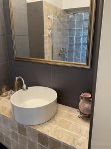 een badkamer met een bad, een spiegel en een wastafel bij Riviera Apartment in Constanţa