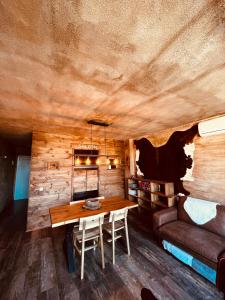 a dining room with a table and a couch at OLD WEST HOUSE Pantano de San Juan in Madrid