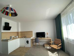 a room with a desk with a computer and a washing machine at Arche Hotel Poloneza in Warsaw