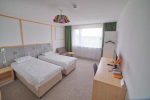 Łóżko lub łóżka w pokoju w obiekcie Arche Hotel Poloneza