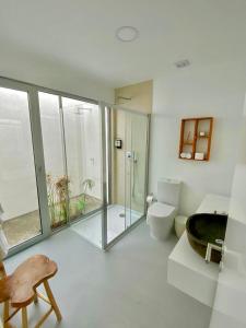 a bathroom with a glass shower and a toilet at Sul Villas & Spa - Azores in Lagoa