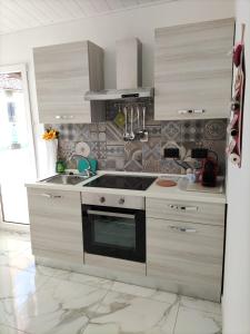 a kitchen with a sink and a stove top oven at La Nina in Sangano