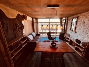 a living room with a table and a couch at OLD WEST HOUSE Pantano de San Juan in Madrid