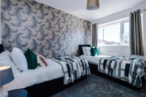 Llit o llits en una habitació de Cheerful 3 bedroom home with parking in Chester
