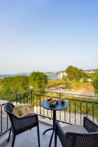 a table and chairs on a balcony with a view at Dandelion apartments in Chania Town