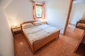 a bedroom with a bed with two lamps on it at Bohinj Star Apartments in Bohinj