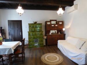 a living room with a table and a couch at Badacsonyi Présház in Badacsonytomaj