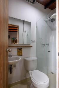 
a bathroom with a toilet a sink and a shower at Med la palma in Medellín
