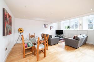 a living room with a table and chairs and a couch at Whinny Brae in Broughty Ferry