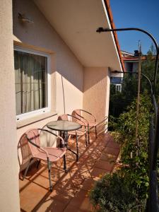 a patio with three chairs and a table and a window at Appartment Štajon in Izola