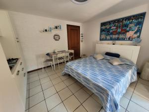 a bedroom with a bed and a table in it at Alimat Apartment in Lignano Sabbiadoro