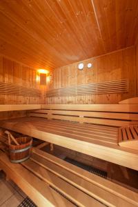 an empty sauna with wooden walls and wooden benches at Haus am Hammerrain in Flachau