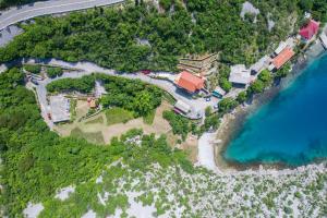 an aerial view of an island with a house and the ocean at Dora Apartment in Senj